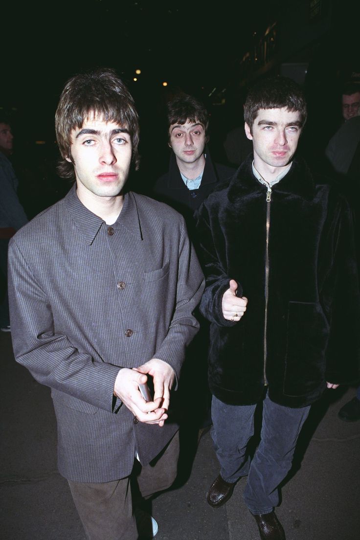 three young men standing next to each other