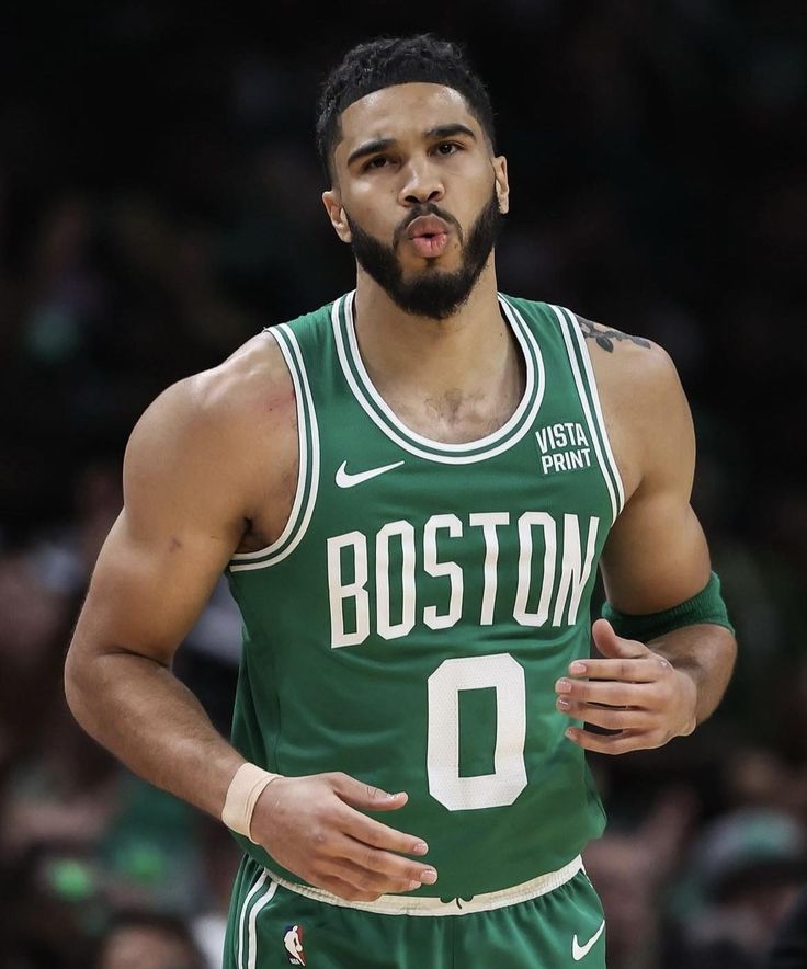 the boston basketball player is making a face while holding his hand on his hip and looking at the camera