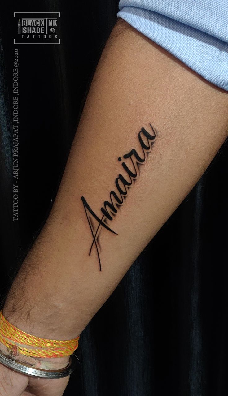 a person with a tattoo on their arm that says amanara in cursive writing