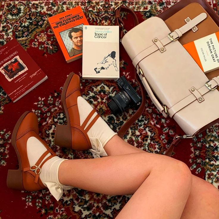 a woman is sitting on the floor with her legs crossed and shoes in front of her