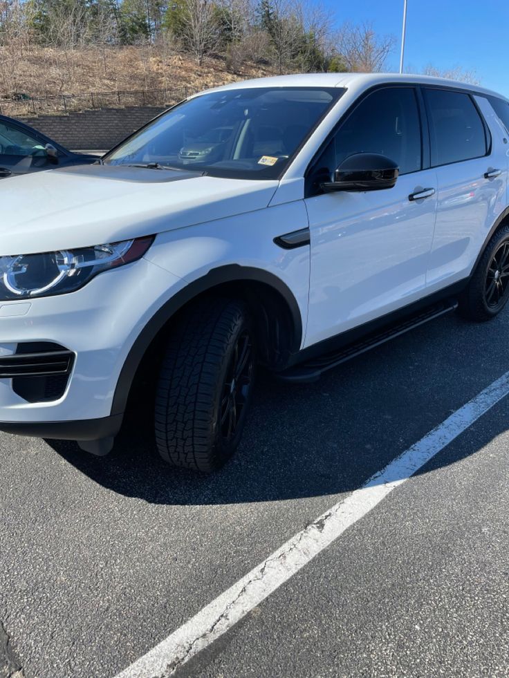 a white suv parked in a parking lot