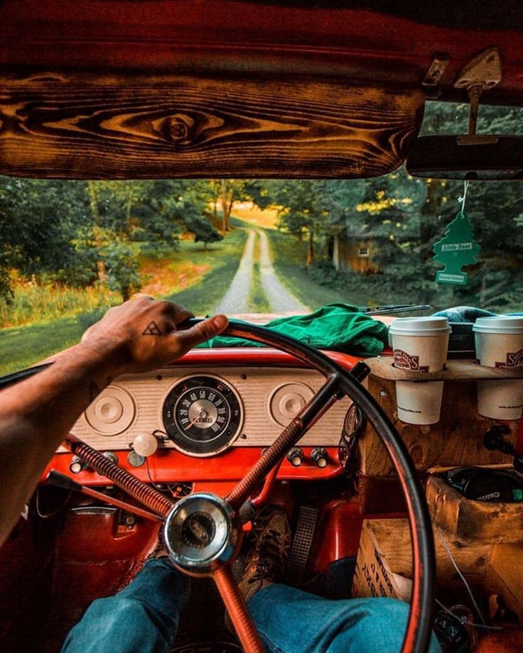 a man driving a truck down a country road