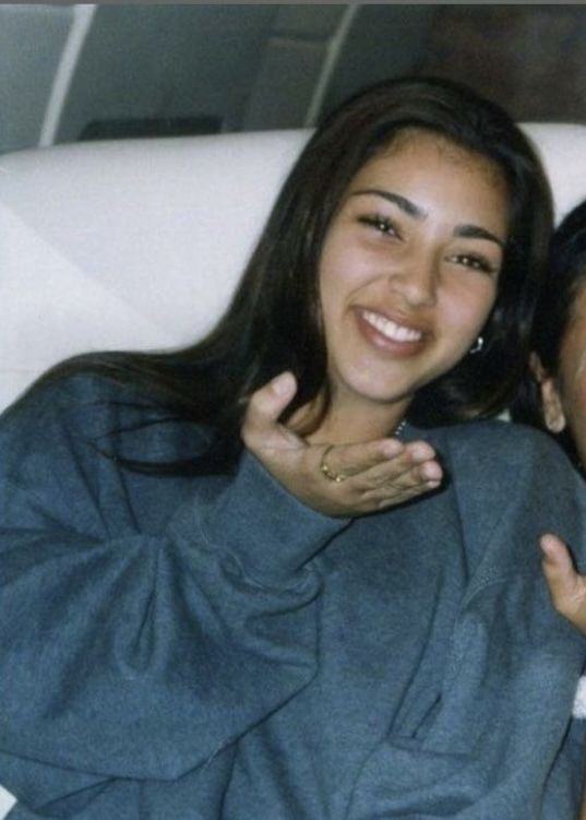 a woman sitting on top of a white couch