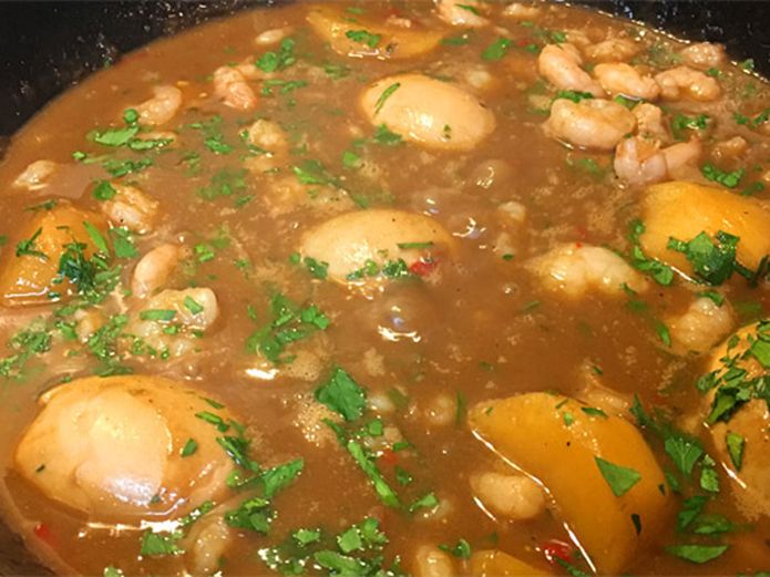 some food is cooking in a pot on the stove