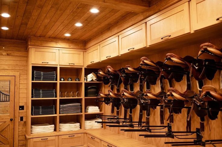 a large wooden closet filled with lots of shoes and hats on shelves next to drawers