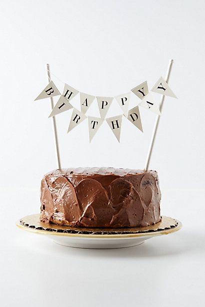 a chocolate cake on a plate with bunting flags