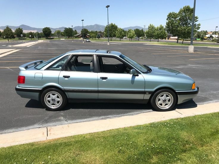 a blue car parked in a parking lot