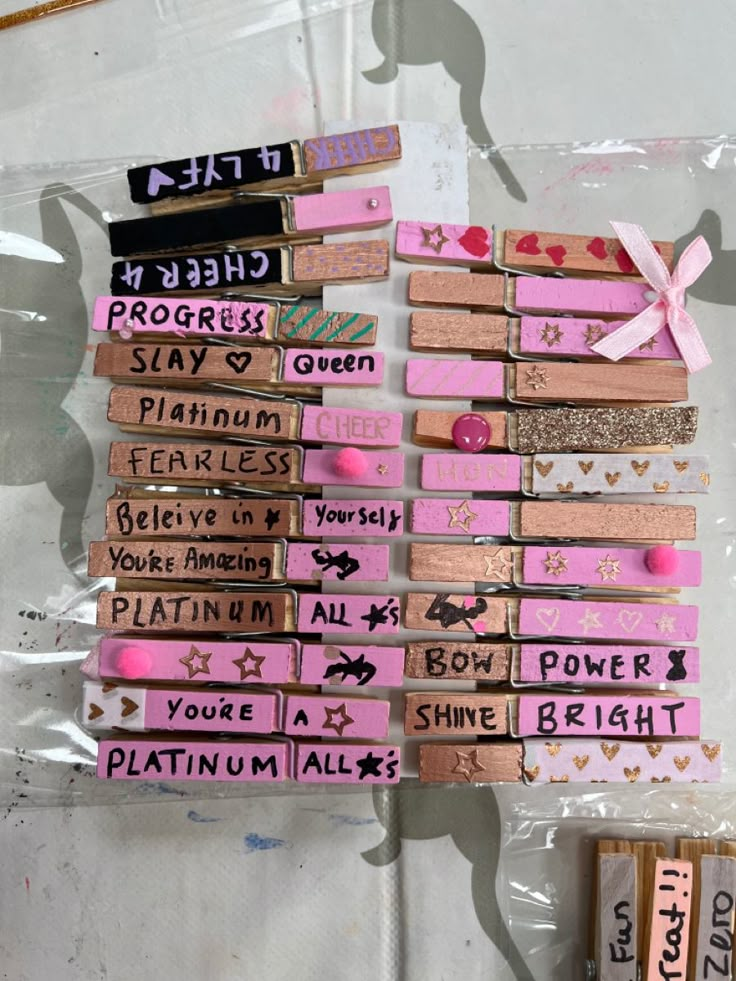 several pieces of pink and black wood with writing on them are arranged in a row