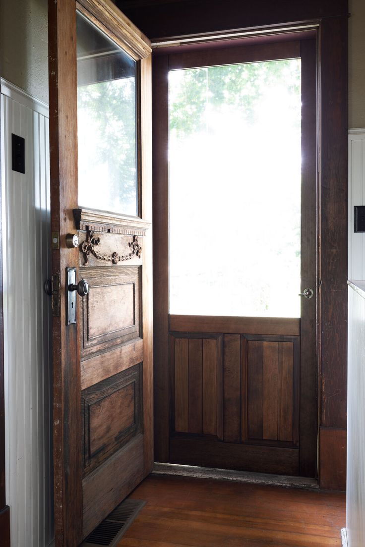 an open wooden door in front of a window