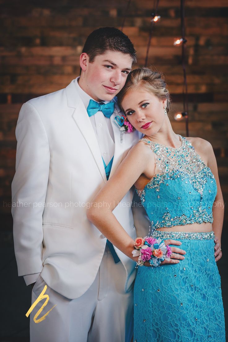 a young man and woman dressed in formal wear