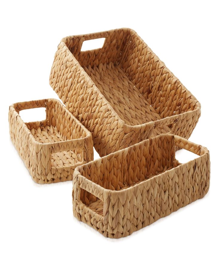 three woven baskets with handles on white background