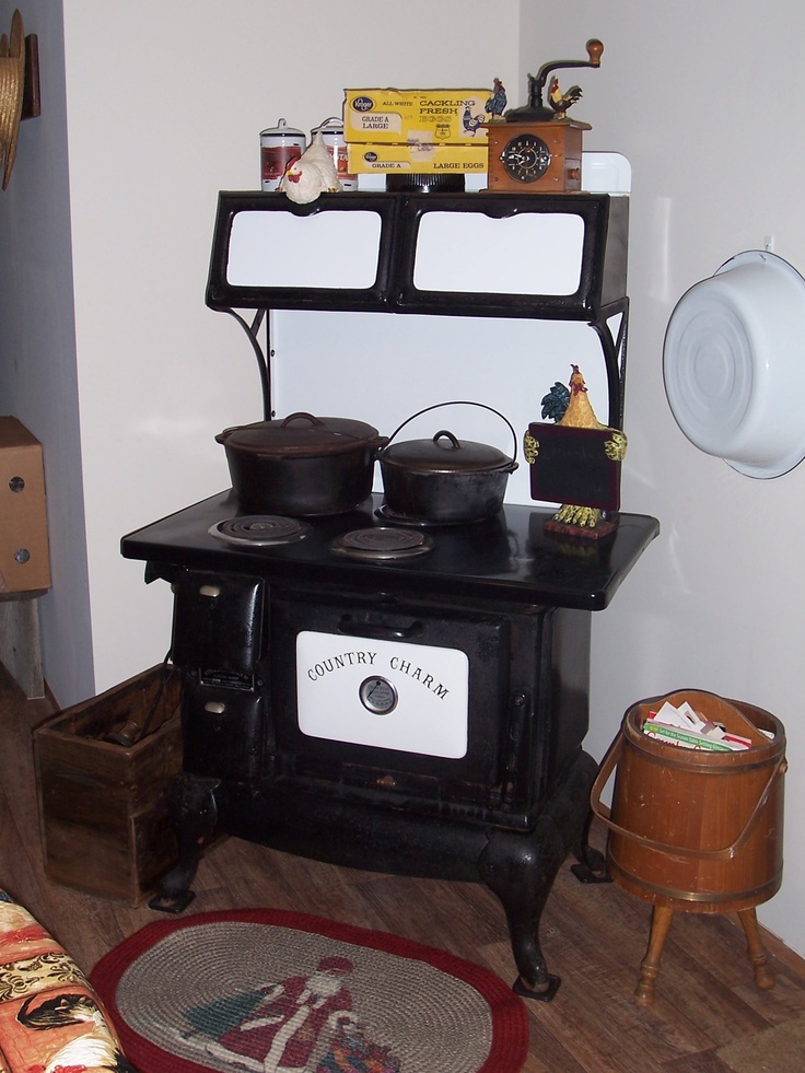 an old fashioned stove with pots and pans on it