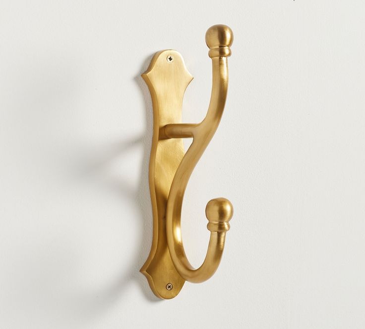 a gold door handle on a white wall