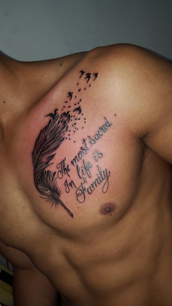 a man with a tattoo on his chest has a feather and some words written in it