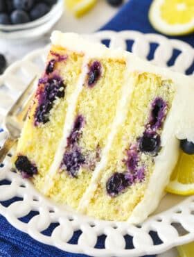 a slice of lemon blueberry cake on a white plate