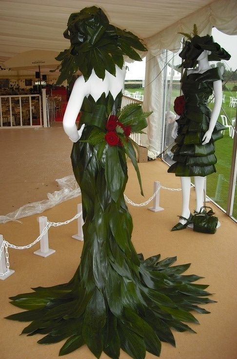 two mannequins dressed in green leaves and flowers