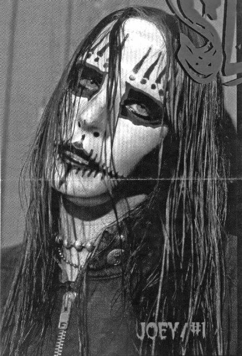 a black and white photo of a woman with makeup on her face, wearing long hair