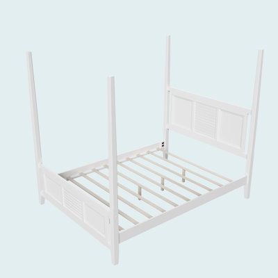 a white bed frame with no headboard and foot board is shown in front of a light blue background