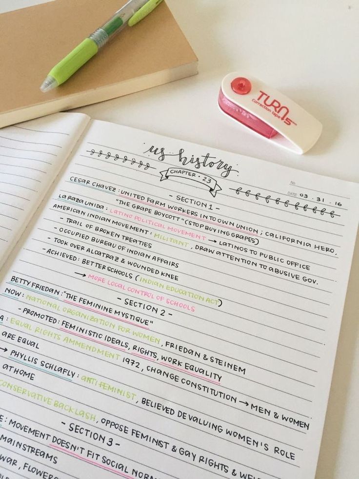 an open notebook sitting on top of a table next to a pen