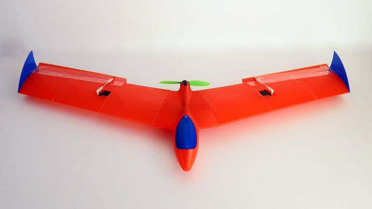 an orange and blue model airplane sitting on top of a table