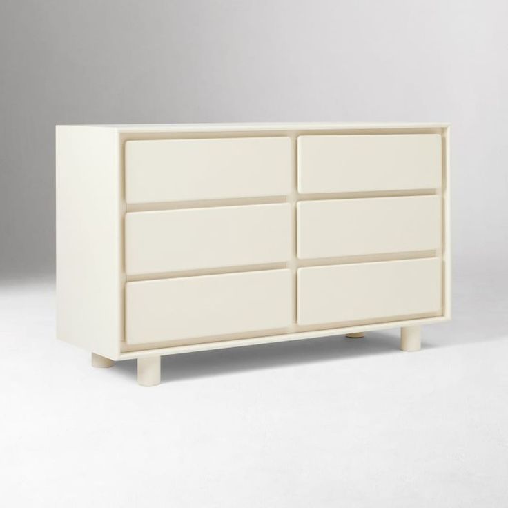 a white dresser sitting on top of a white floor