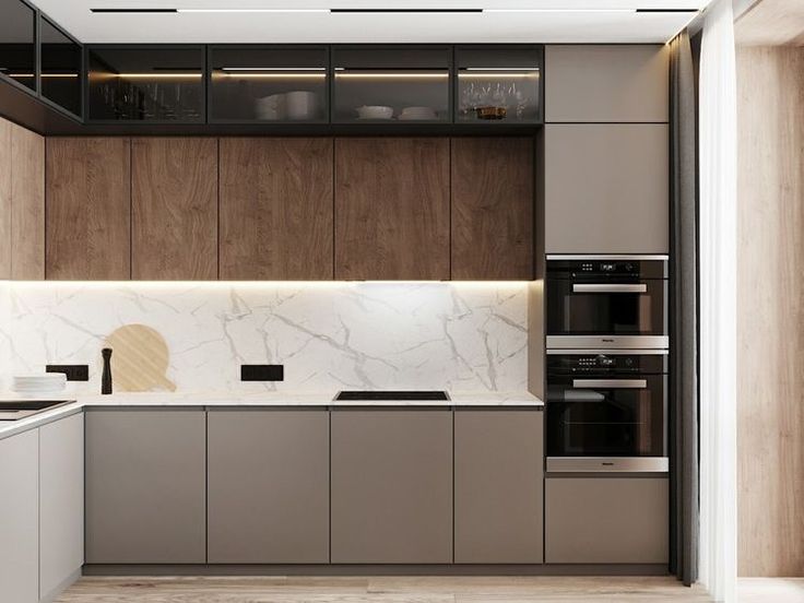 a modern kitchen with marble counter tops and wooden cabinetry, along with stainless steel appliances