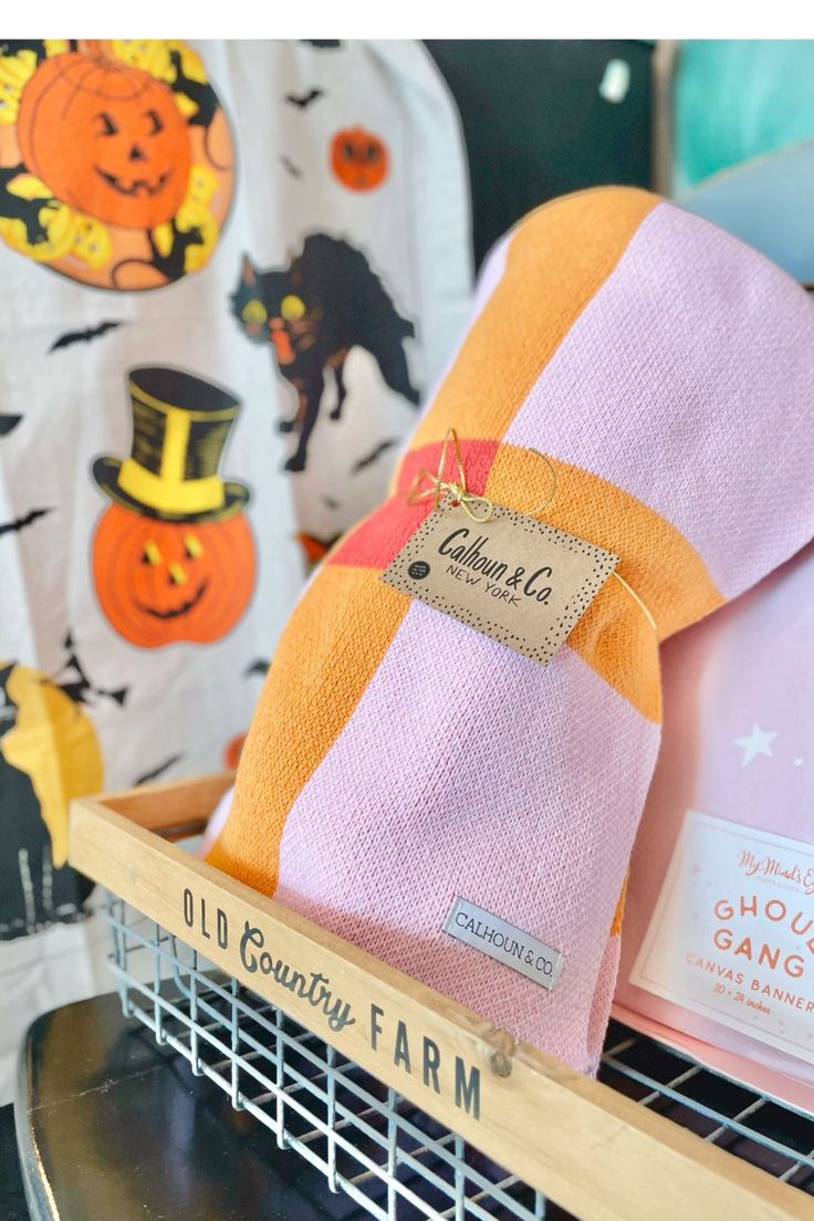 an orange, pink and yellow towel sitting on top of a shelf