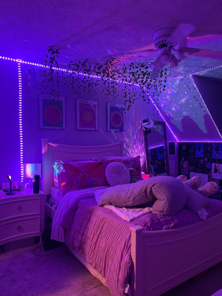 a bed room with a neatly made bed and purple lights on the ceiling above it