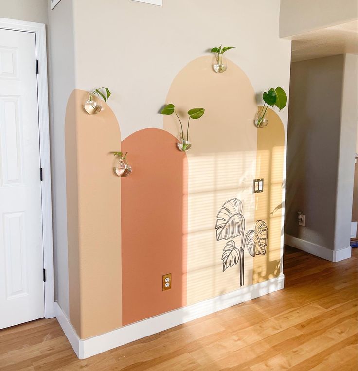 an empty room with some plants on the wall