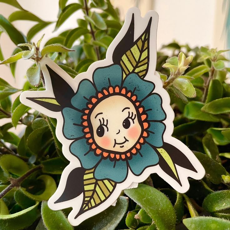 a flower sticker sitting on top of a potted plant