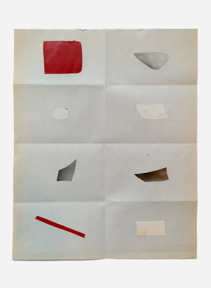 several pieces of paper with different shapes and sizes on them, including one red strip