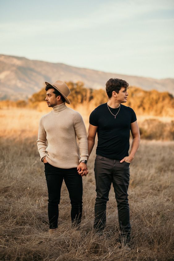 two men standing in the middle of a field