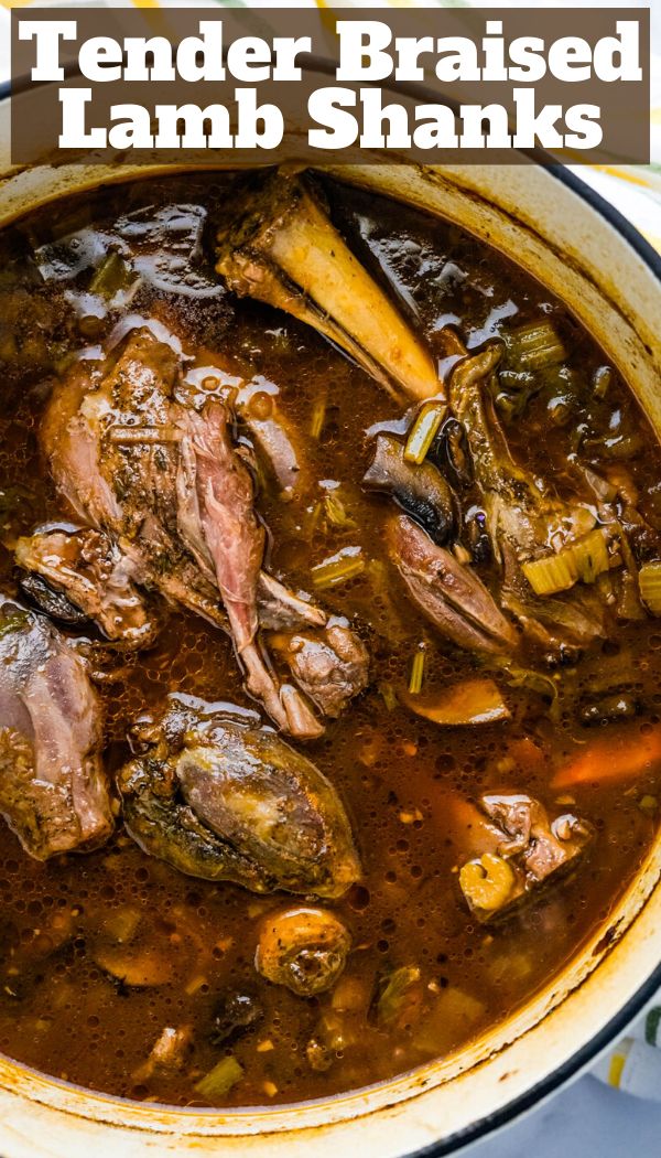 a pot full of lamb shanks with text overlay that reads tender braised lamb shanks