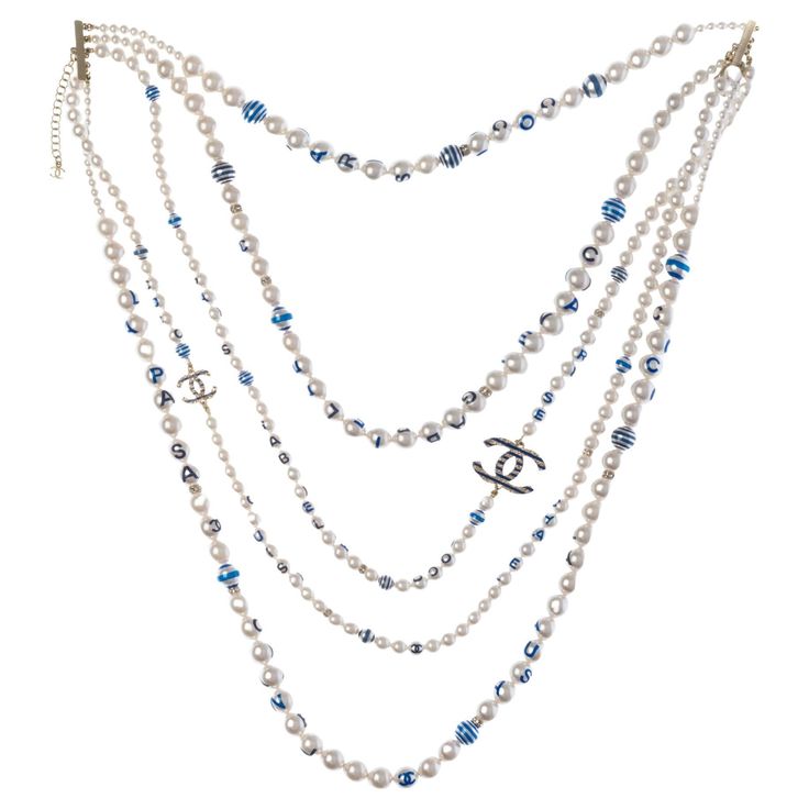 Chanel​ ​CC​ ​long​ ​necklace​ ​in​ ​white​ ​pearly​ ​pearls​ ​and​ ​gold​ ​metal​ ​with​ ​blue​ ​inscriptions​ ​in​ ​5​ ​rows Length:​ ​37cm Reference:​ ​101449 General​ ​condition:​ ​7.5/10 Sold​ ​with​ ​box Pearl Gold Necklace, Chanel Pearl, Necklace With Pearl, Chanel Pearls, Chanel Necklace, Crystal Chandelier Earrings, Beaded Tassel Earrings, Gold Pearl Necklace, Chanel Jewelry