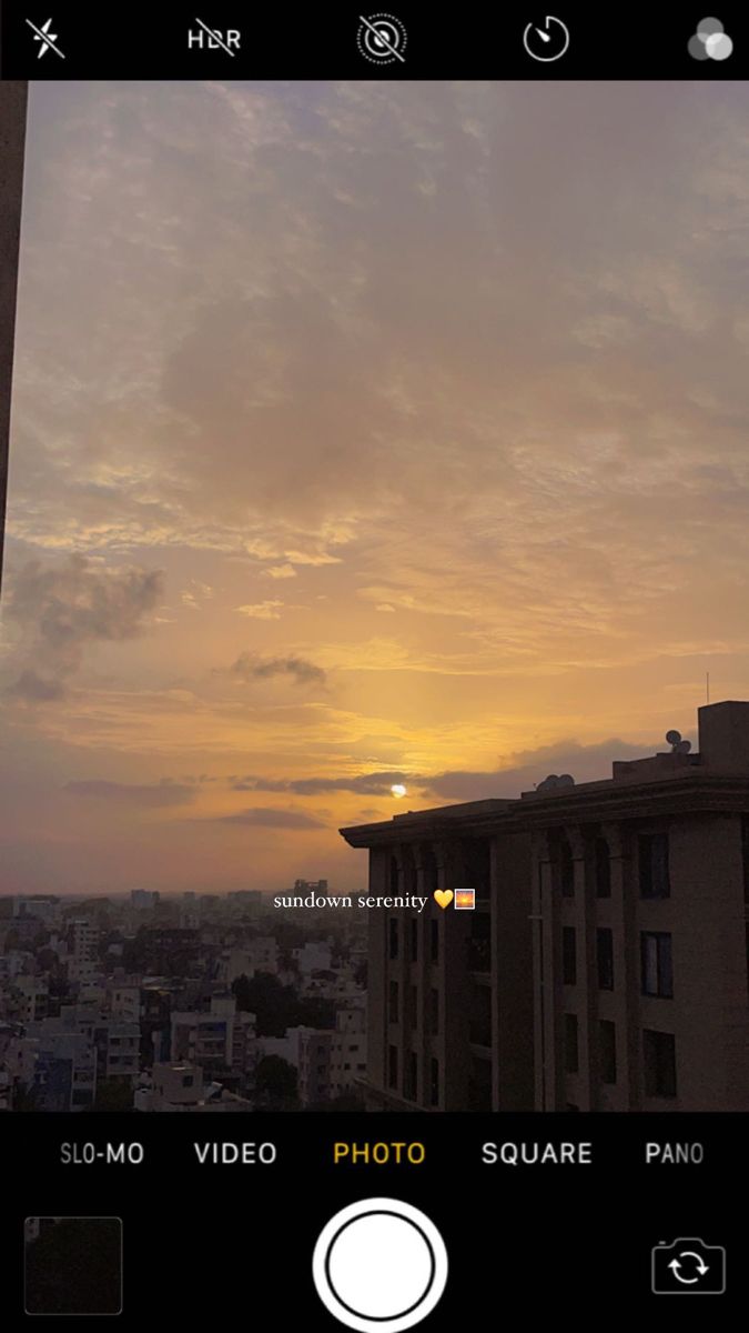 the sun is setting over some buildings