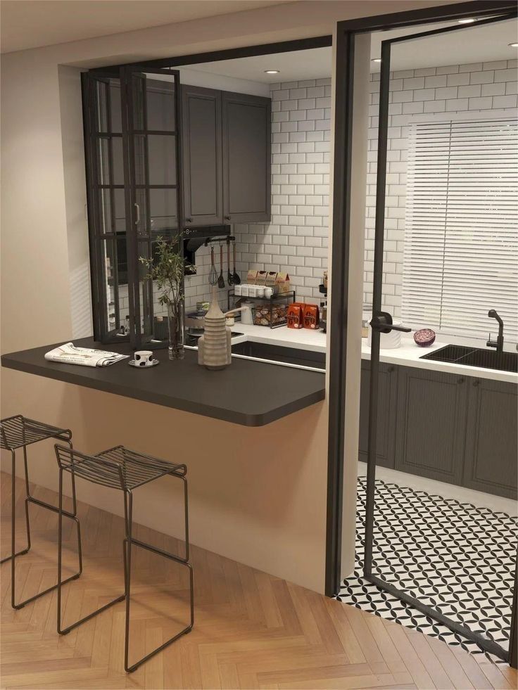 a kitchen with black and white tiles on the walls, counter tops and stools