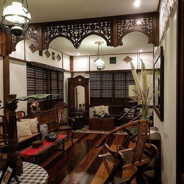 an ornately decorated living room with wooden furniture