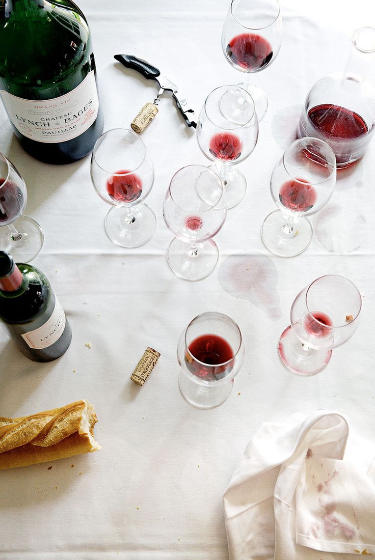 several wine glasses and bottles on a table