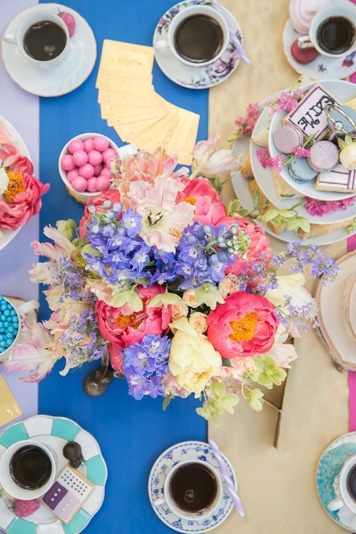 a table topped with lots of plates and cups filled with different types of food next to each other