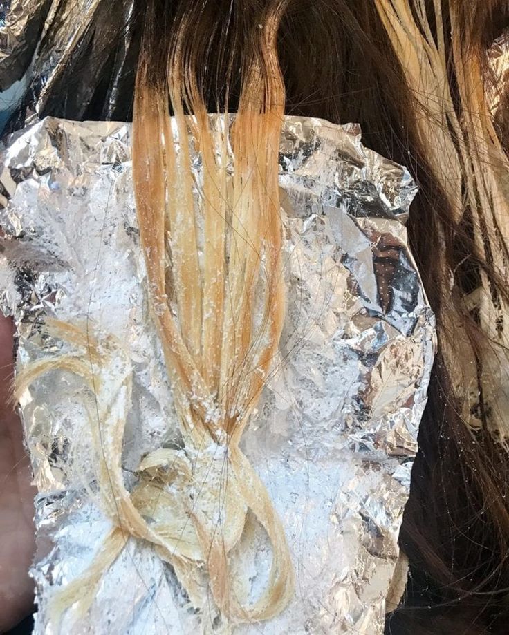 someone is cutting their hair with scissors on tin foil and it looks like they have been cut