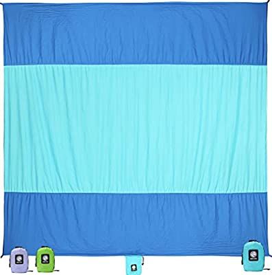 a blue and green blanket sitting on top of a white floor