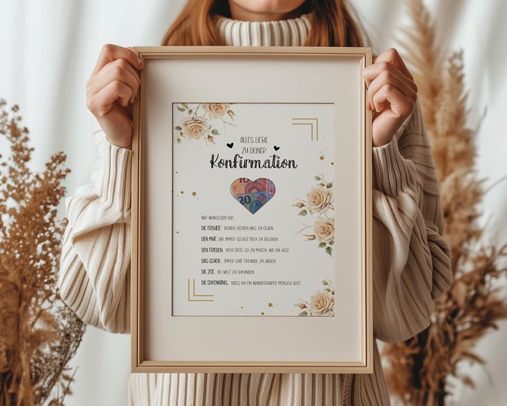 a woman holding up a framed poster with the words, i love you in german