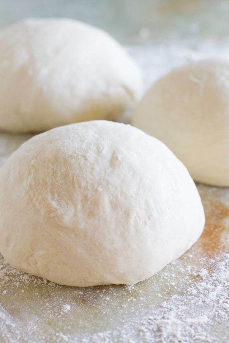 two doughnuts sitting on top of a table next to each other with the words homemade pizza dough