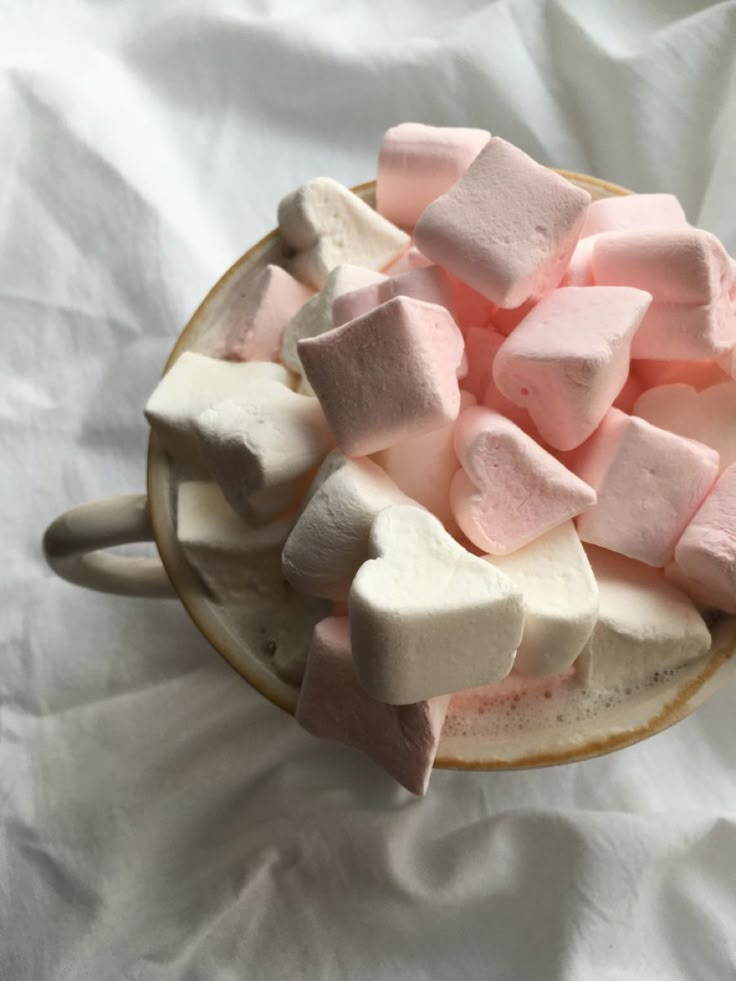 marshmallows in a bowl on a white sheet