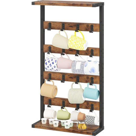 a wooden rack with cups and mugs on it, hanging from the wall in front of a white background