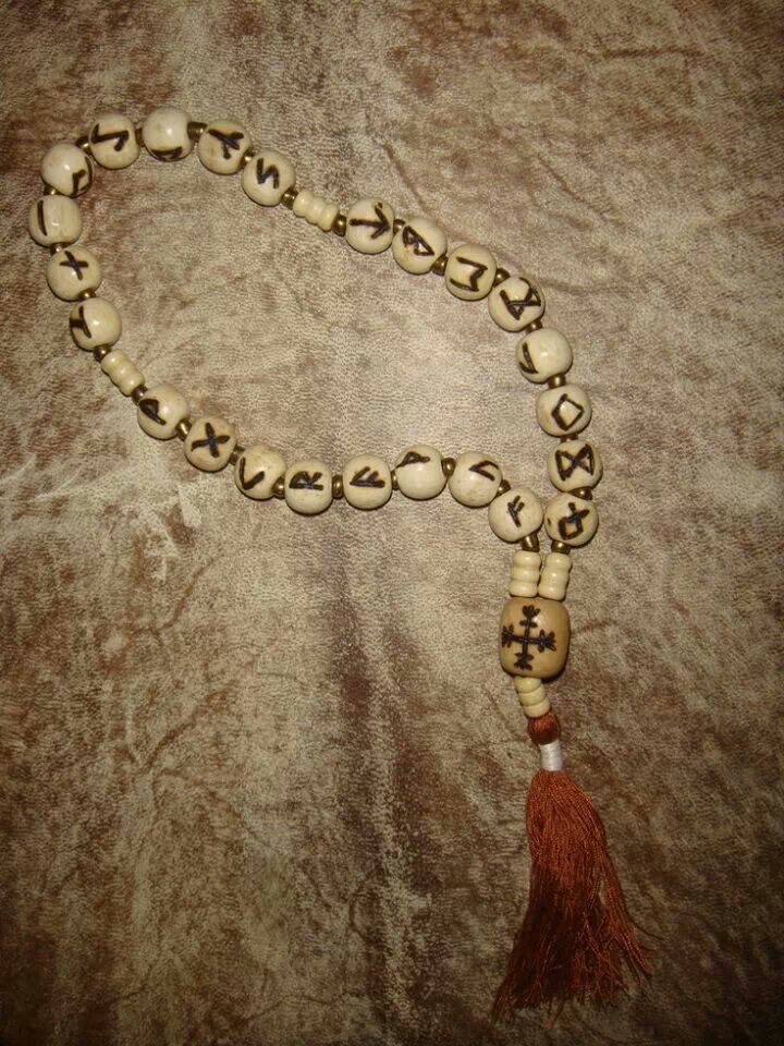 a wooden beaded necklace with a tassel