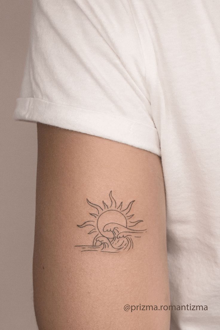 a person with a sun tattoo on their arm