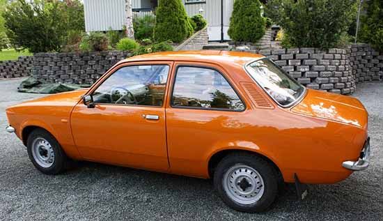 an orange car parked in front of a house