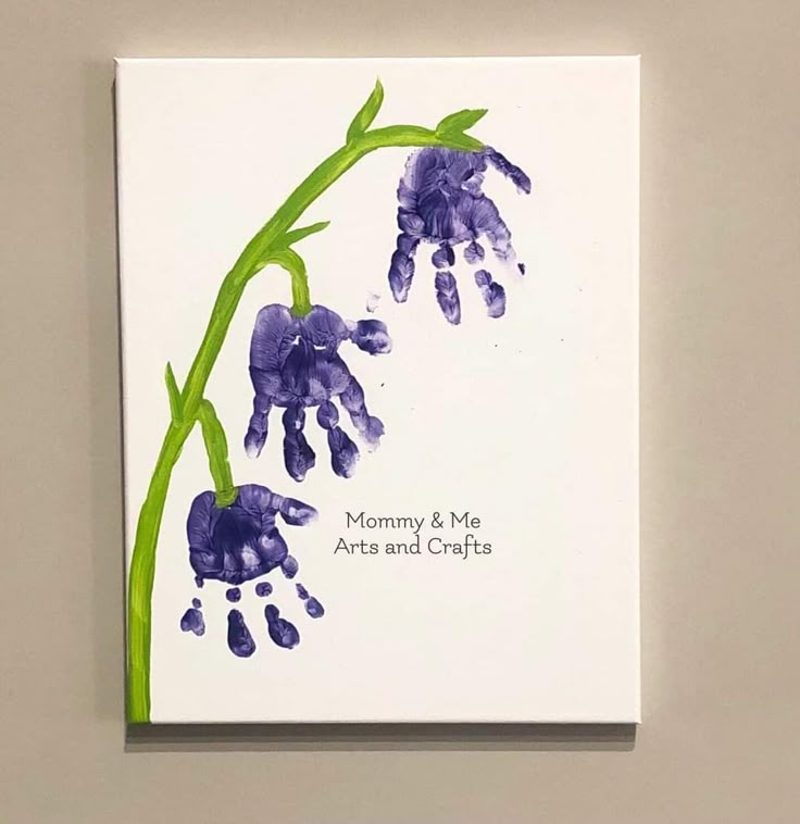 a card with purple flowers and green stems