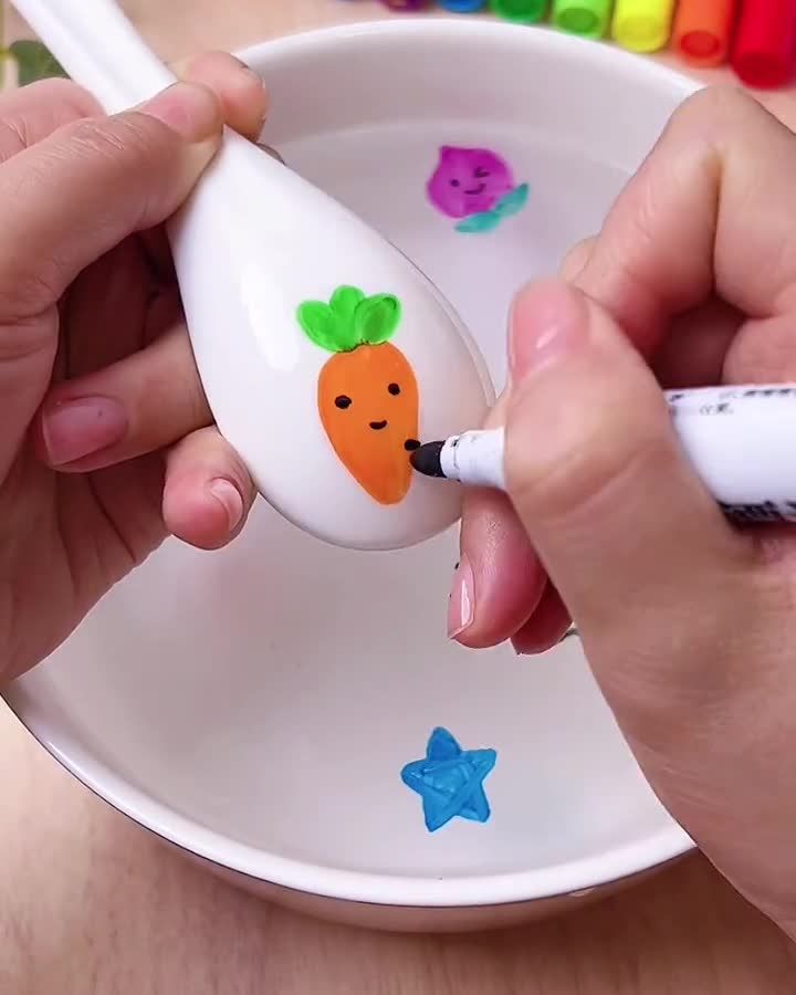 a person is drawing on an egg with colored crayons in the shape of carrots